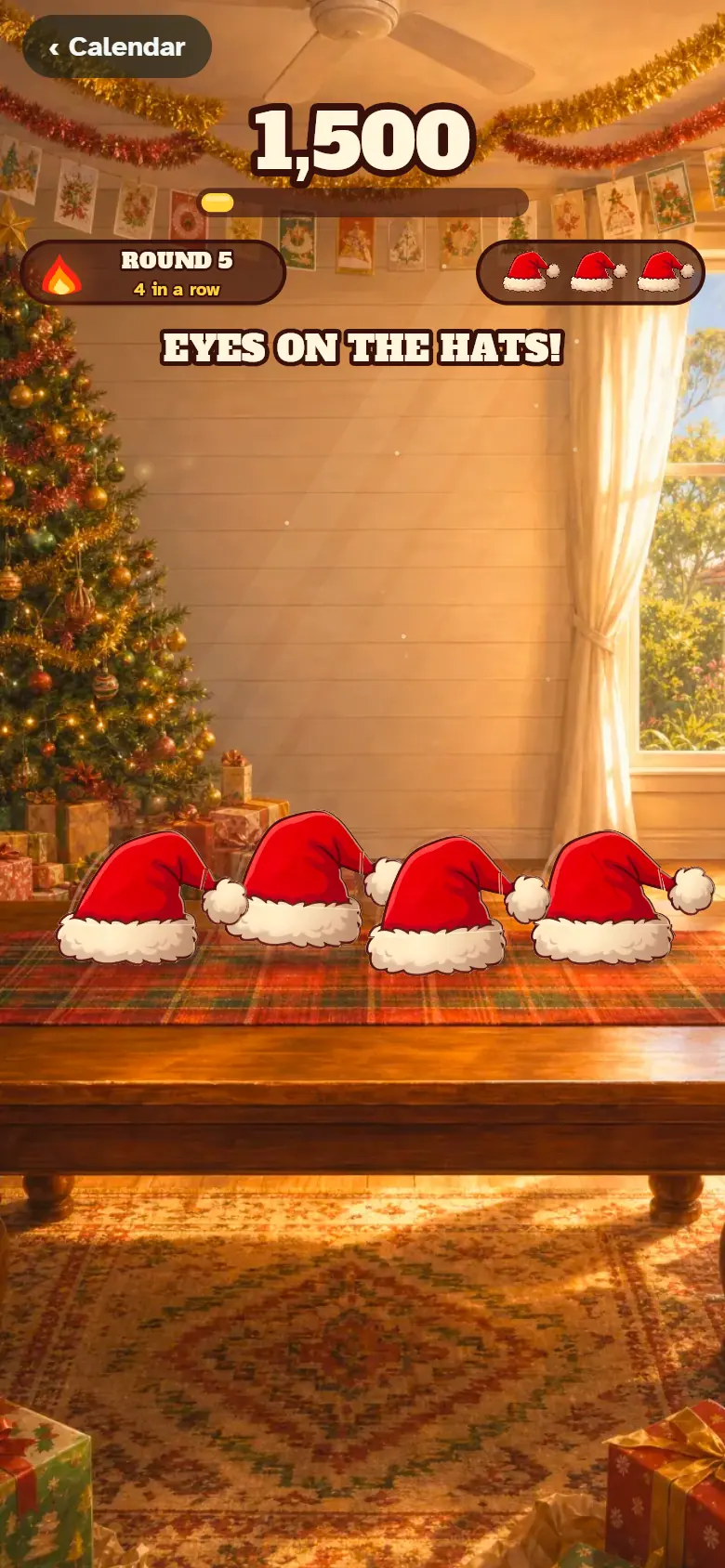 A row of Santa hats on a wooden table, about to shuffle, in the memory game Secret Santa Shuffle.